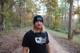Adam wearing the black Sport Beanie on a woodland trail