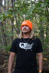 Adam wearing the Blaze Orange Sport Beanie in the woods
